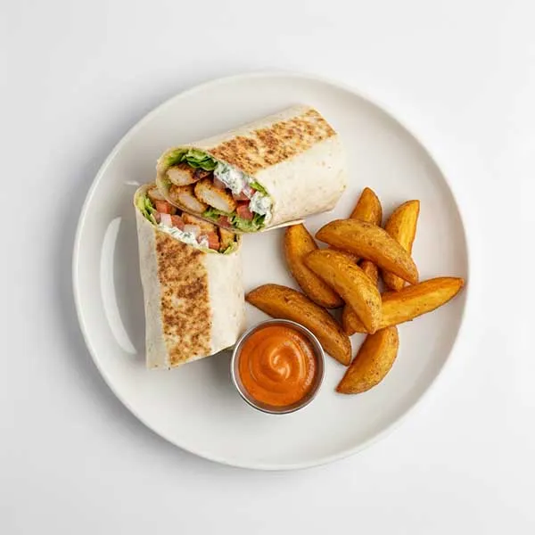Tzatziki spiced chicken wrap with potato wedgesand harissa mayo